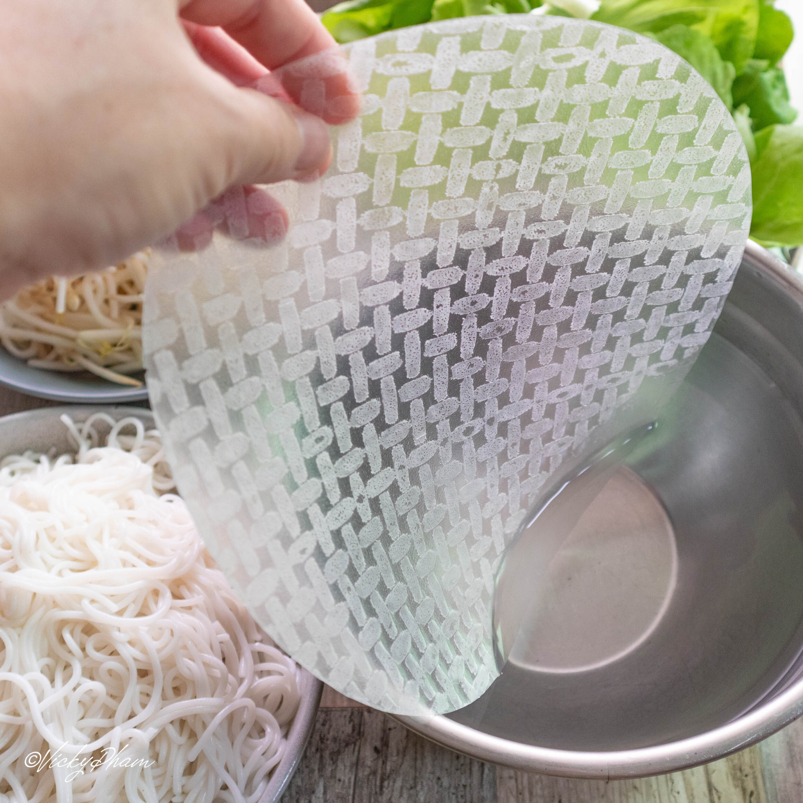 Soak the rice paper in Pho Cuon